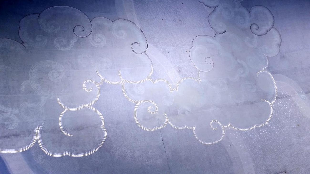 A blue and white picture of the stylized clouds from the ceiling mural of Bridges Auditorium